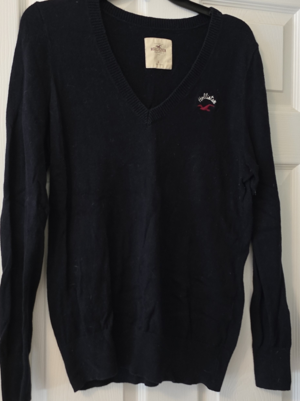 Hollister Women's V-Neck Navy Sweater with Red Logo